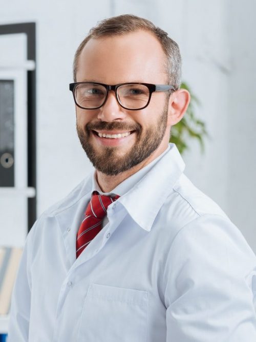 portrait-of-smiling-male-chiropractor-in-white-coat-and-eyeglasses-with-notepad-in-hospital-e1630005297244.jpg portrait-of-smiling-male-chiropractor-in-white-coat-and-eyeglasses-with-notepad-in-hospital-e1630005297244.jpg